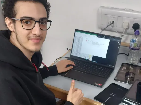 Ayman giving a thumbs up while sorting through donated iPads